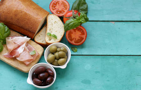 Parma ham, black and green olives - traditional italian foodの写真素材