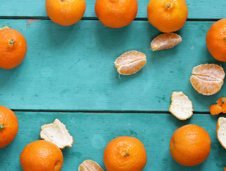 fresh organic mandarins on a turquoise wooden backgroundの写真素材