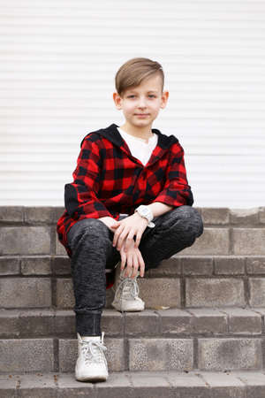 Blond cute boy in casual clothes posing on white backgroundの写真素材