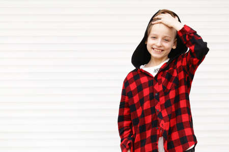 Blond cute boy in casual clothes posing on white backgroundの写真素材