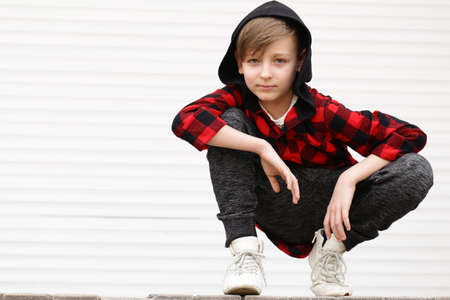 Blond cute boy in casual clothes posing on white backgroundの写真素材