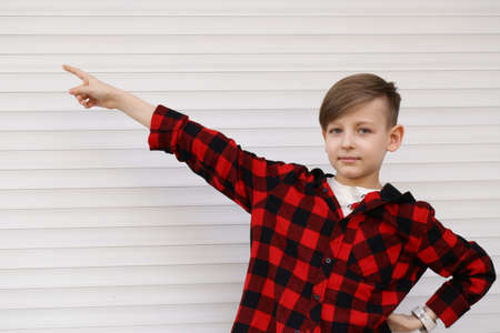 Blond cute boy in casual clothes posing on white backgroundの写真素材