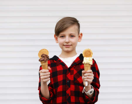 Cute young boy eating ice cream in waffle cone