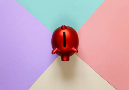 red piggy bank on a colorful backgroundの写真素材