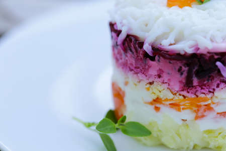 layered salad with beets, fish and potatoesの写真素材