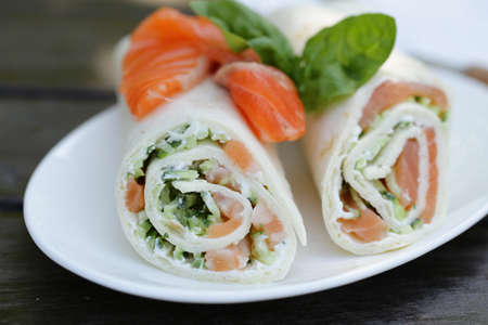 tortilla with a red fish vegetables and saladの写真素材