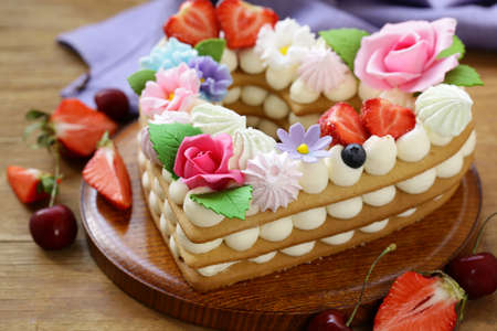 honey cake with mascarpone cream and decorated with flowersの写真素材