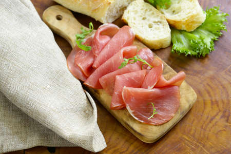 smoked ham of pork on a wooden board