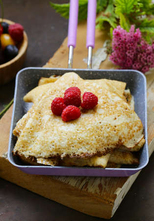 thin pancakes stack in a frying pan, rustic still life