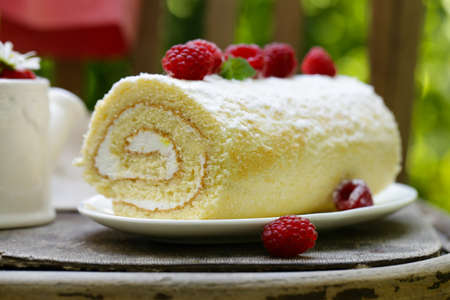 biscuit roll dessert with fresh berries, rustic style