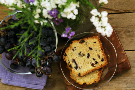fruit cake with raisins on a wooden table