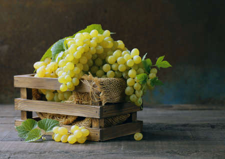 organic white green grapes on a wooden backgroundの写真素材