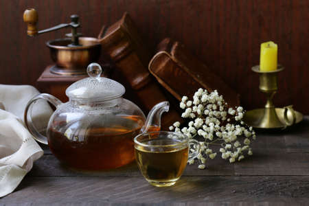 kettle with tea on a wooden table rustic still lifeの写真素材