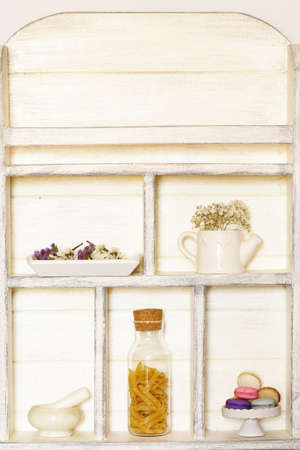 kitchen wooden white cupboard background with utensils and food