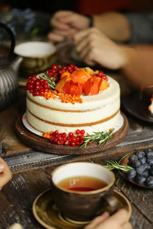 family party at the table, cake and teaの写真素材