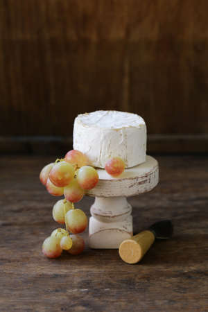 cheese board soft cheese, nuts and grapesの写真素材