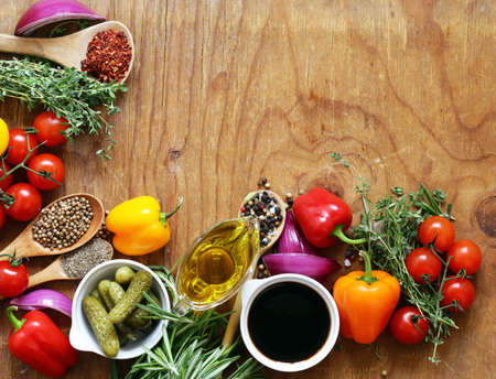 herbs and spices, vegetables and sauces on wooden backgroundの写真素材