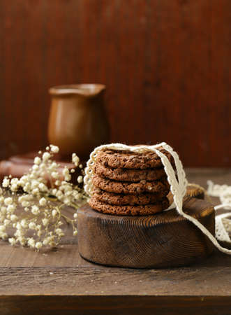 stack of chocolate chip cookies on a wooden tableの写真素材