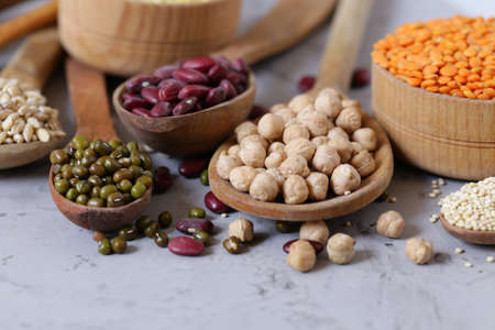various cereals in wooden spoons, healthy foodの写真素材