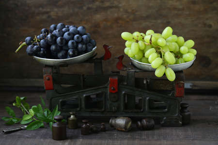 organic ripe grapes on scales, rustic style