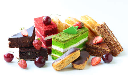 desserts cakes on a white background with berries and cream
