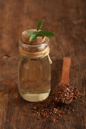 natural organic flaxseed oil on a wooden tableの写真素材