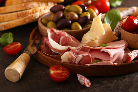 Italian food, prosciutto, olives, cheese and tomatoesの写真素材