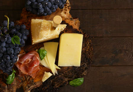 cheeseboard on a wooden table, rustic style