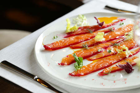 salted red fish salmon on a plate with aromatic herbsの写真素材