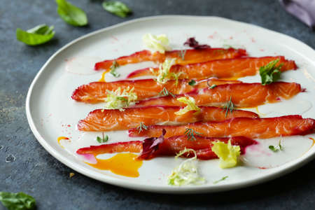 salted red fish salmon on a plate with aromatic herbsの写真素材
