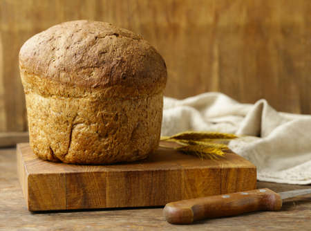 homemade rye bread on a wooden boardの写真素材