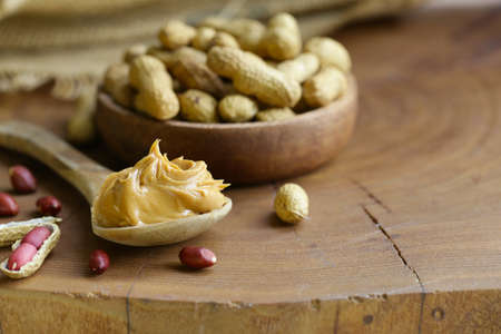 natural organic peanut butter on a wooden table