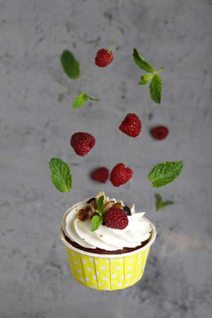 cream cupcakes with raspberries for dessert