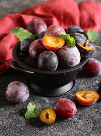 fresh organic red plums on the tableの写真素材