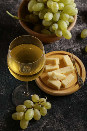glass with white wine and green grapesの写真素材