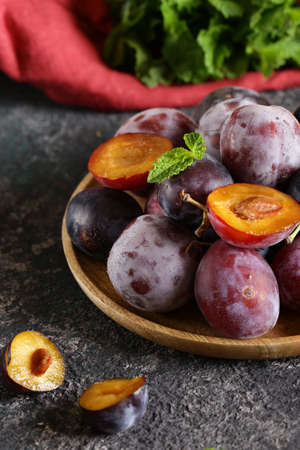 fresh organic red plums on the tableの写真素材