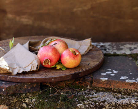 fresh organic natural fruit pomegranates with leavesの写真素材