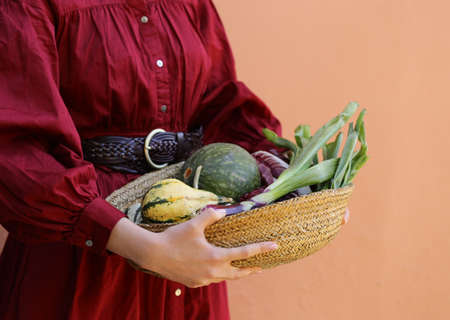 autumn vegetables harvest in a wicker basketの写真素材