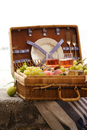 picnic basket with fruit and wine