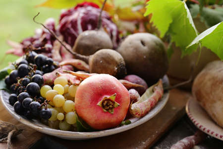 autumn fruits and vegetables on a wooden tableの写真素材