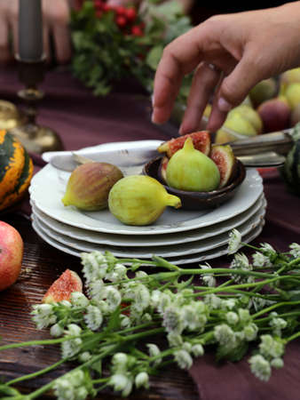 festive autumn table setting with fruits and cheeseの写真素材