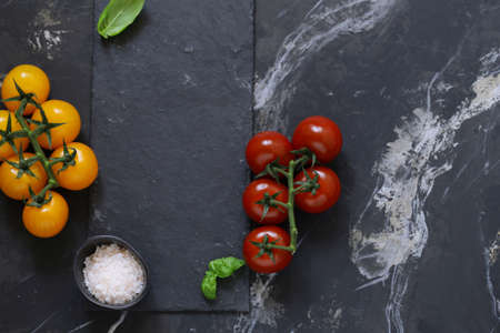 background for food menu, black graphite and tomatoesの写真素材