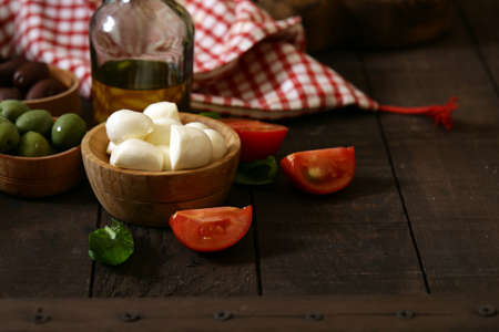 mini mozzarella cheese in a wooden bowl
