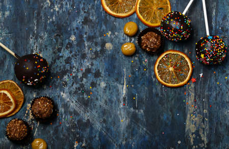 Homemade cakes cake pops on a stick with chocolate and sweetsの写真素材