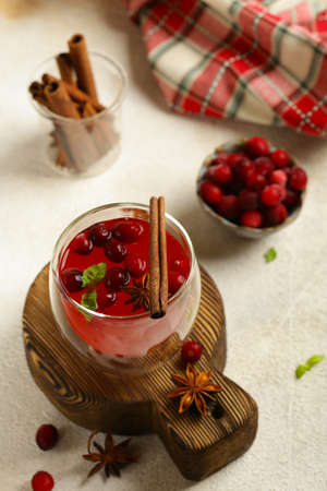 tea in a glass with cranberries and cinnamon