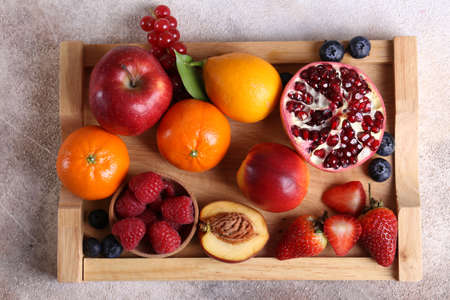 fruits and berries on a wooden tray