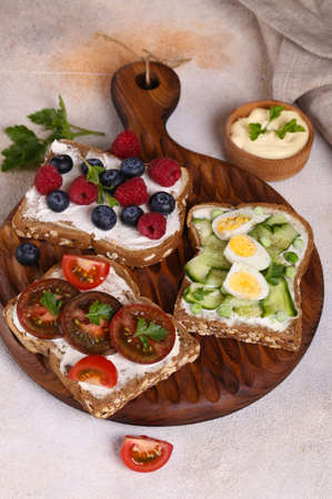 various sandwiches for a healthy diet on a wooden boardの写真素材