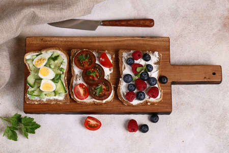 various sandwiches for a healthy diet on a wooden board