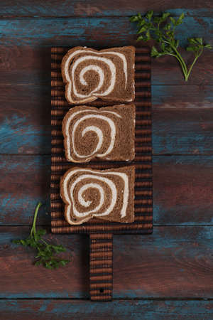whole wheat rye sliced bread on a wooden board