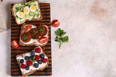 various sandwiches for a healthy diet on a wooden boardの写真素材